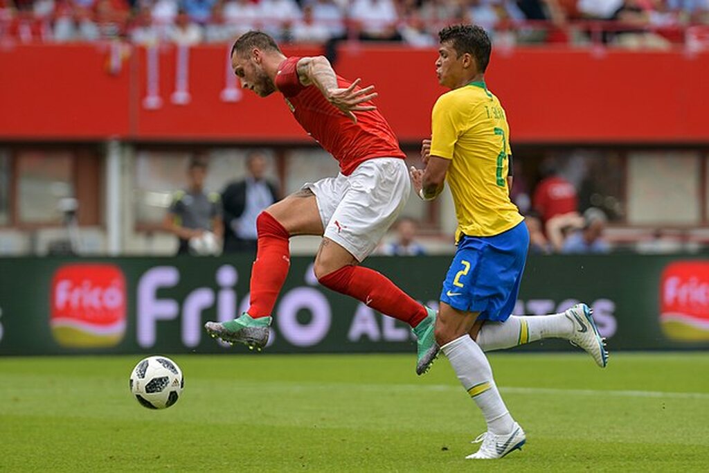 thiago silva, um dos capitaes da seleção brasileira, disputando a bola em campo