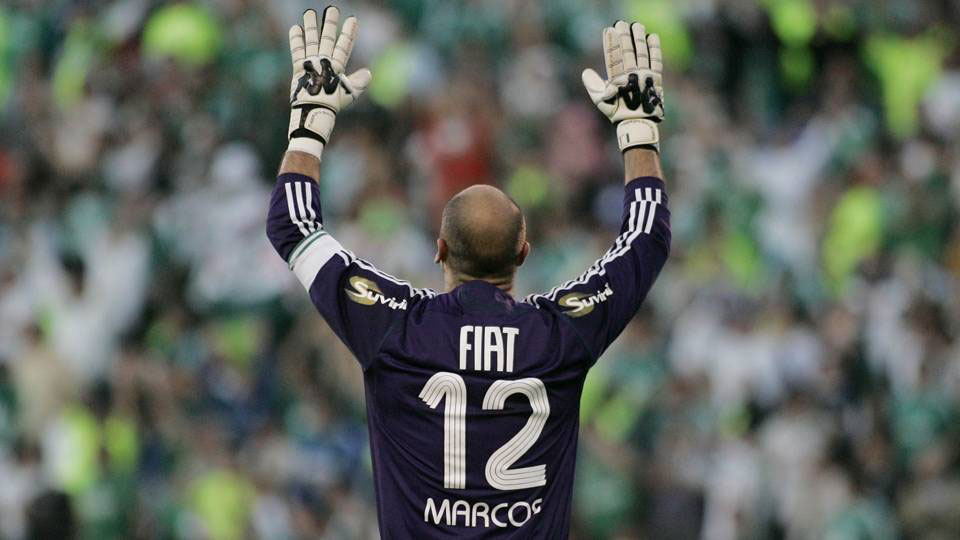 Ex-goleiro do Palmeiras e da seleção brasileira, Marcos, com uniforme do time erguendo as mãos para o alto.