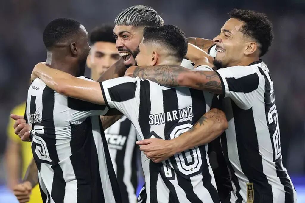 jogadores do botafogo em campo comemorando a vitória